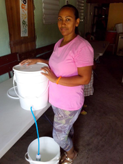 Marilyn Perez with a clean water filtration system